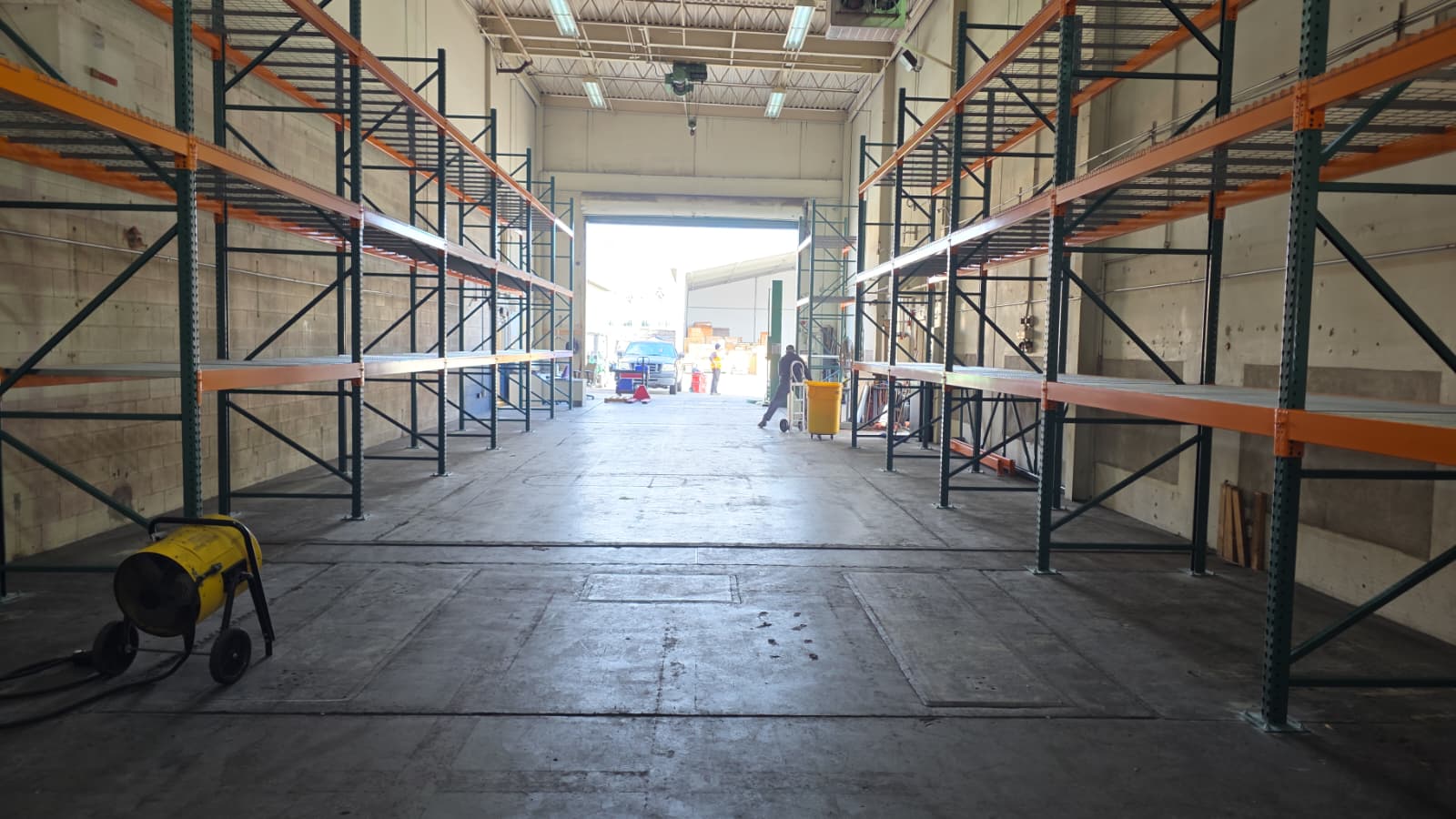 Newly installed selective pallet rack aisle at a U.S. Air Force facility in San Diego: Nucor selective racking with wire decking, completed by Hammerhead under GSA Schedule contract 47QSMS24D007E to replace the existing system and meet seismic force protection requirements.
